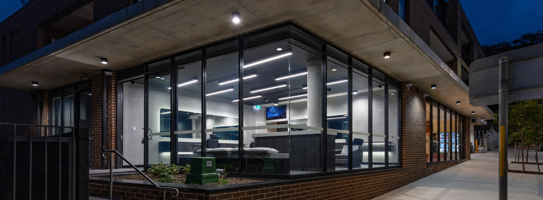 Surface-mounted downlights illuminating the exterior walkway outside OL Mates in Earlwood